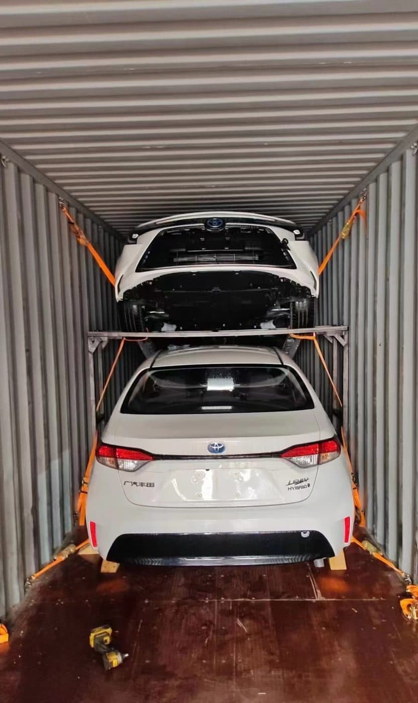 Cars stacked on racking inside a container
